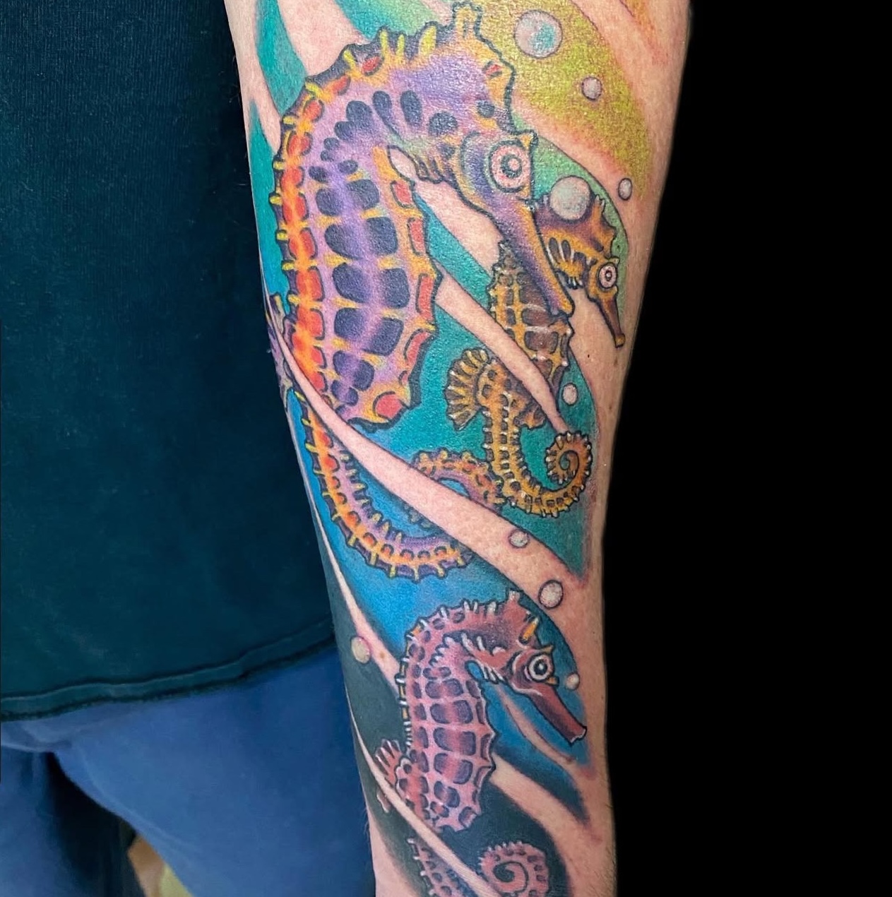 Vibrant colorful seahorses tattoo
